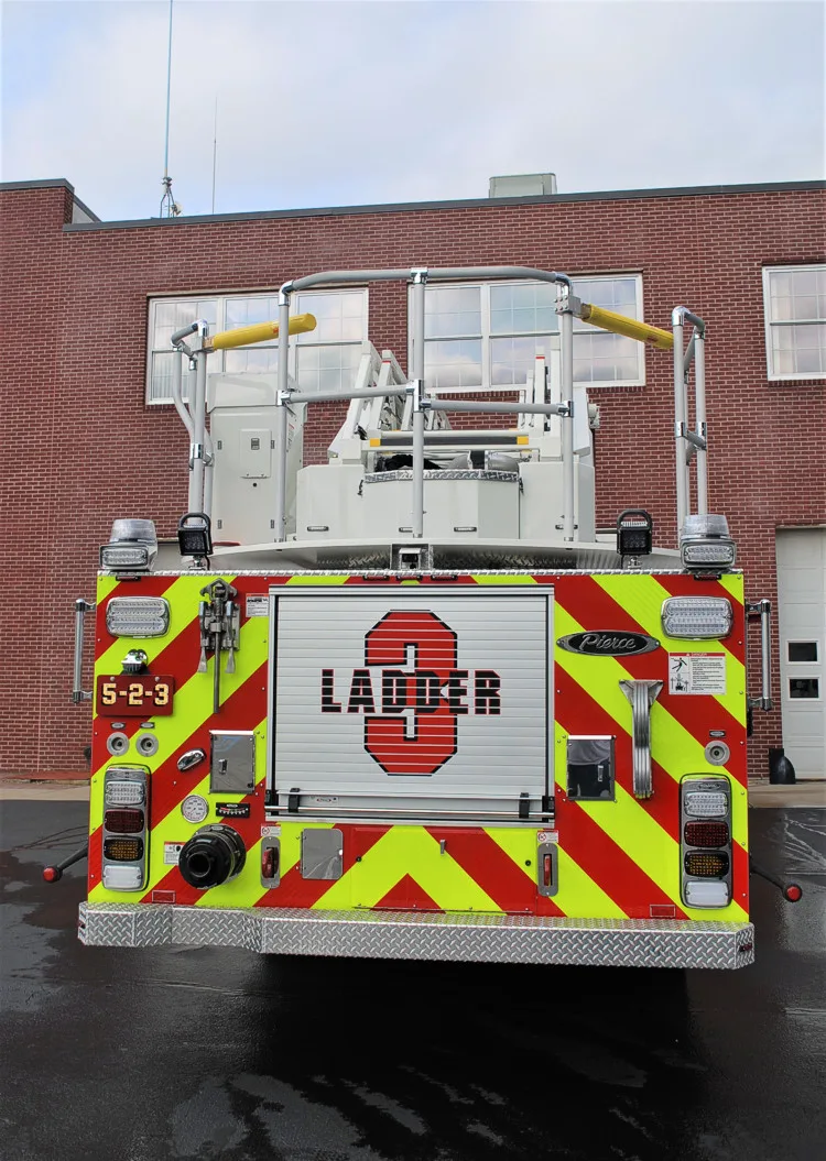 Rear view showing chevrons, rear compartment opening, and ladder base