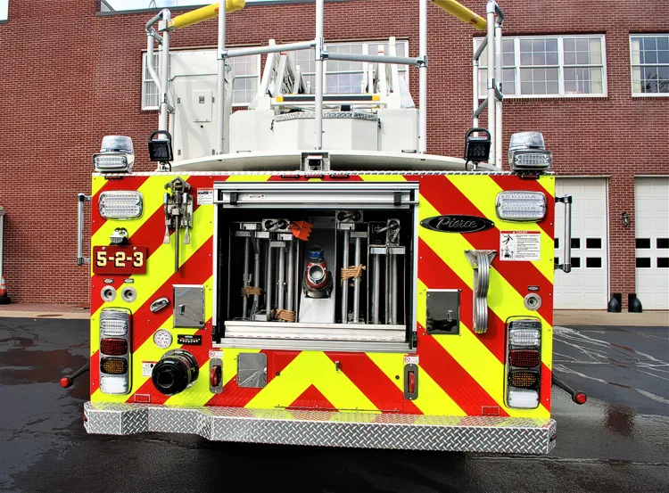 Rear view showing red-and-yellow chevrons and open rear compartment