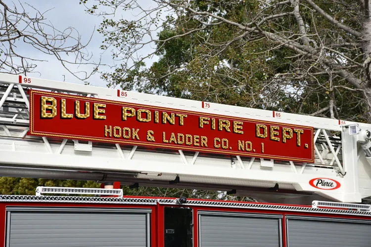 Body side lettering close-up above side compartments on white stripe