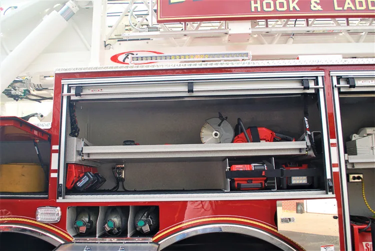 Open side compartment showing shelf bays with tools and equipment cases