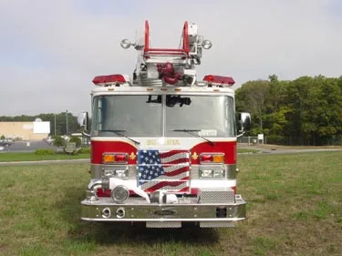 Front exterior view showing grille, bumper, and roof-mounted ladder tip