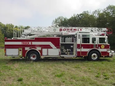 Driver-side profile with open pump panel showing gauges and side compartments