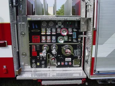 Pump panel close-up showing gauges, valves, and intake controls