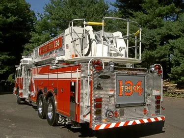 Rear-right exterior view showing rear platform section and warning lights