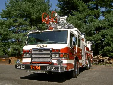 Front exterior view showing grille, bumper, and warning lights