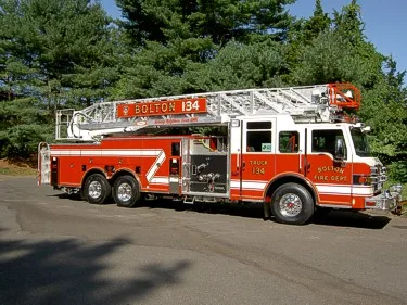 Driver-side profile view showing ladder sections and side compartments