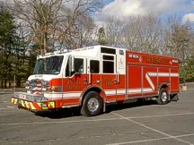Rescue pumper front-left exterior view showing bumper, cab, and side compartments