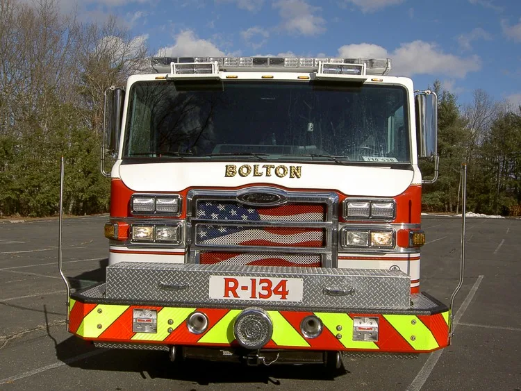 Front exterior view showing grille, bumper intake, and warning lights