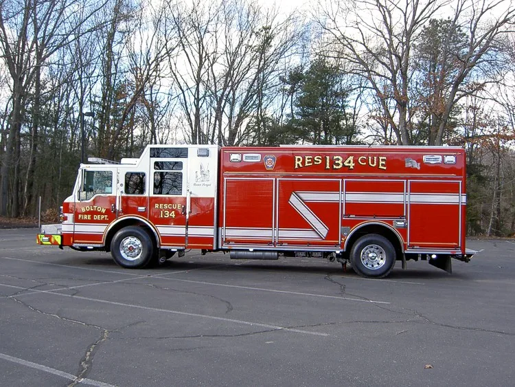 Driver-side full profile view showing long rescue body and wheelbase