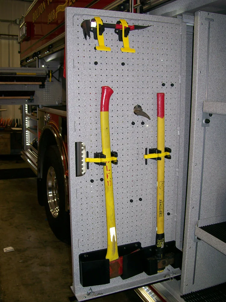 Open side compartment showing long-tool rack and mounted adapters