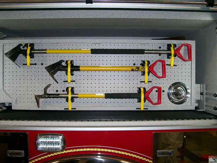 Open side compartment showing mounted hand tools in horizontal rack