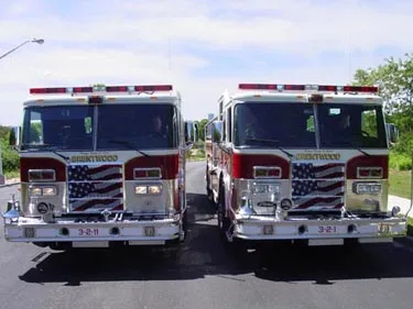 Head-on front view showing two similar pumpers parked side by side