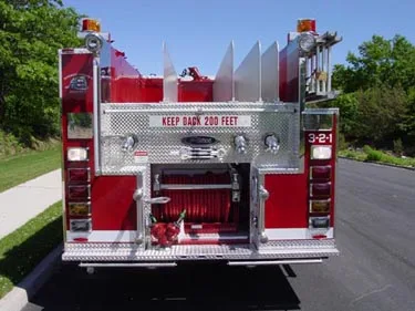 Rear view showing red-and-white chevrons and rear pump controls