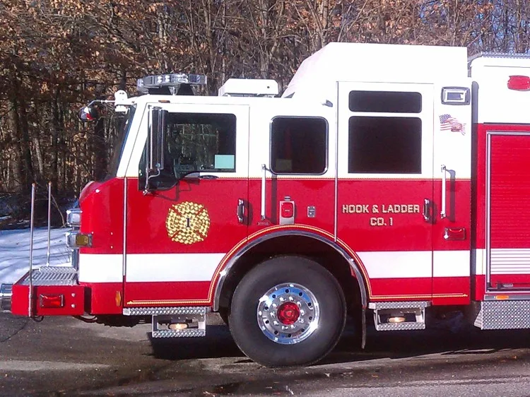 Cab-side close view showing front wheel area, crew cab doors, and side body transition.