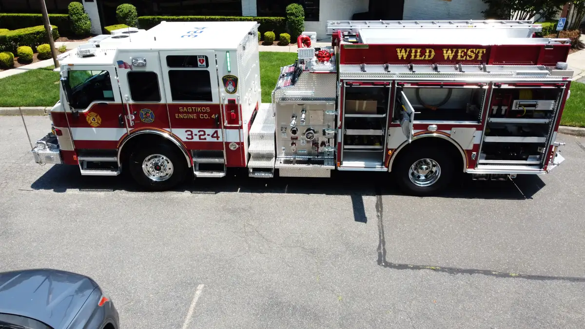 Pierce pumper aerial side profile with multiple open compartment doors