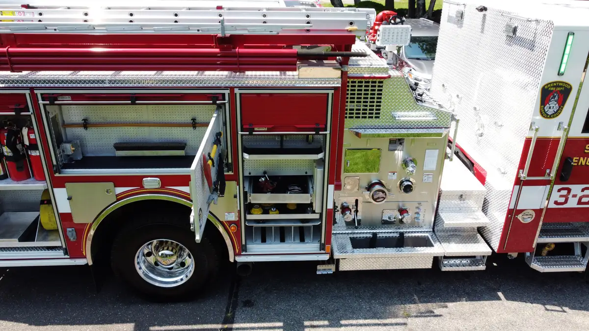 Pierce pumper aerial close-up of side pump panel area and open lower compartments