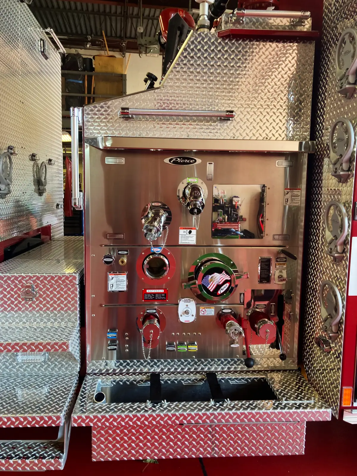 Top-mount pump panel close-up showing intake connections, valve controls, and gauge cluster