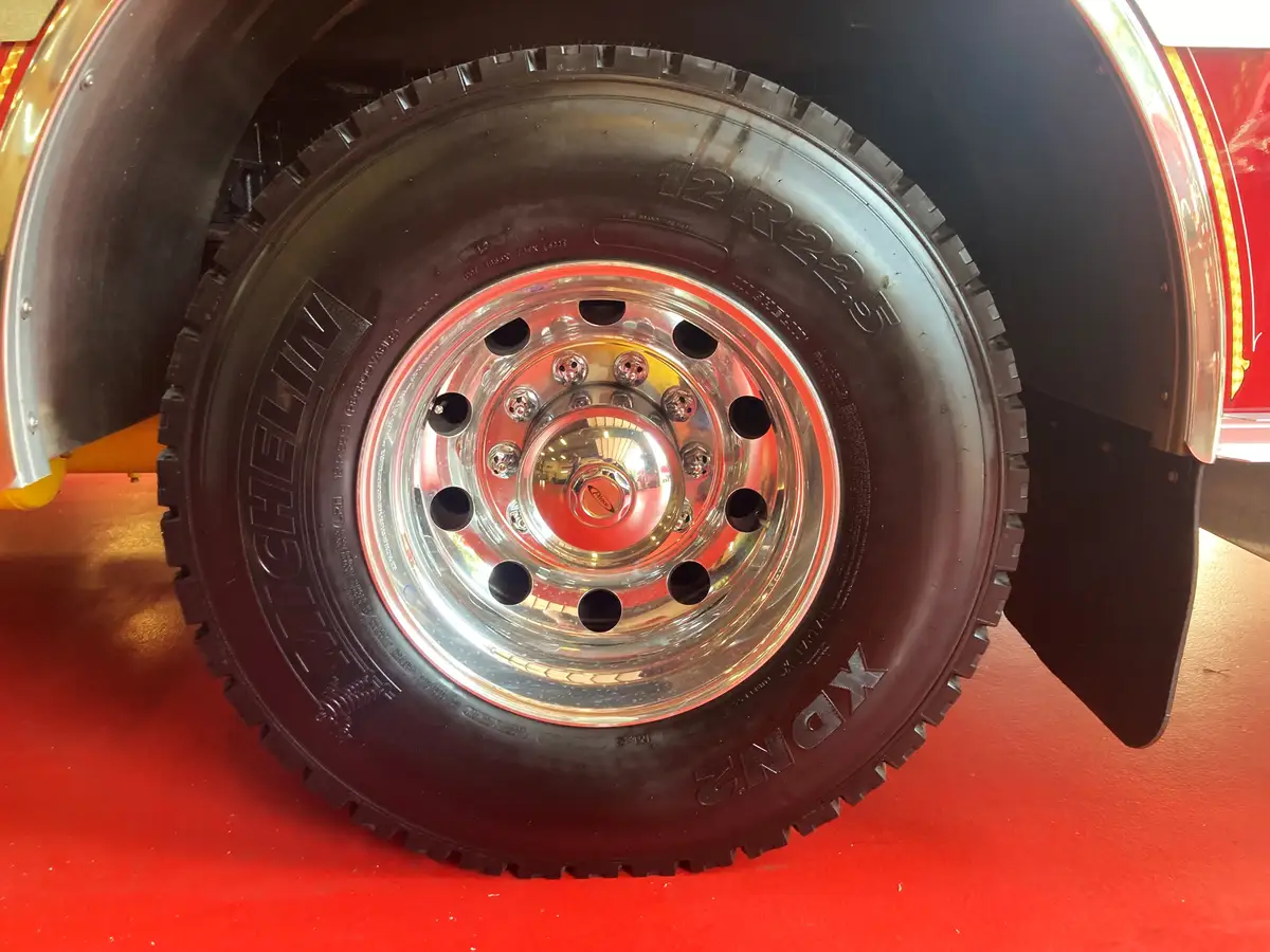 Pierce pumper rear view showing chevron striping, rear warning lights, and hosebed door
