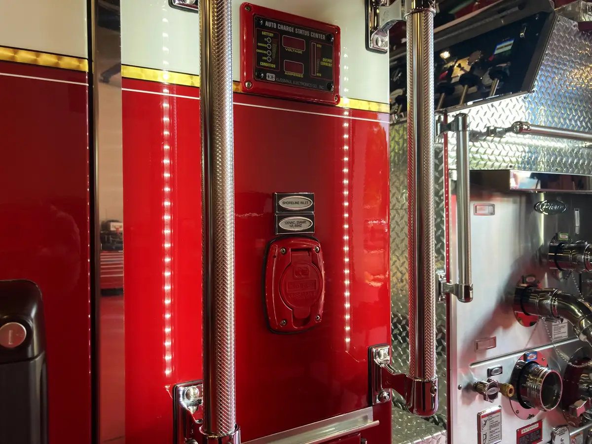 Cab-side control panel close-up with outlet cover and LED marker strip