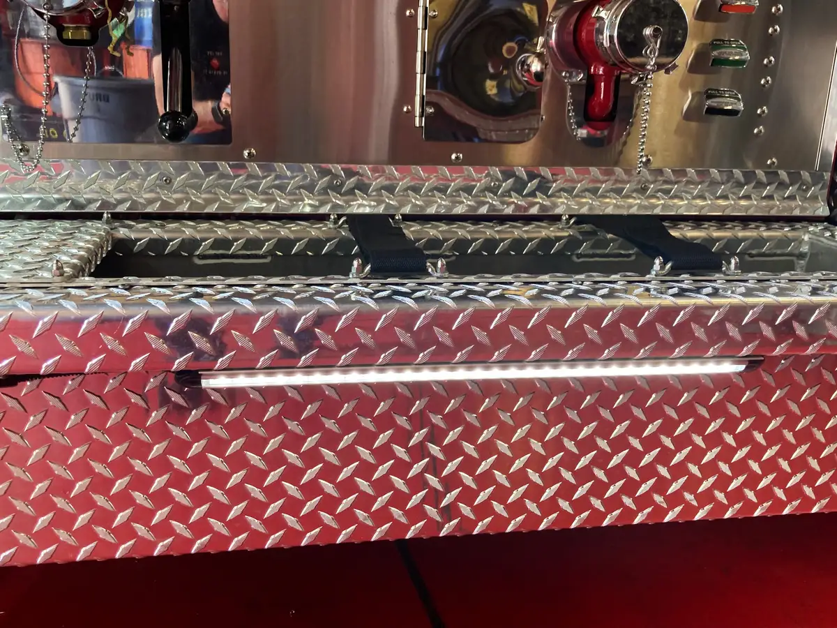 Cab interior wide view showing driver area, center console, and steering wheel