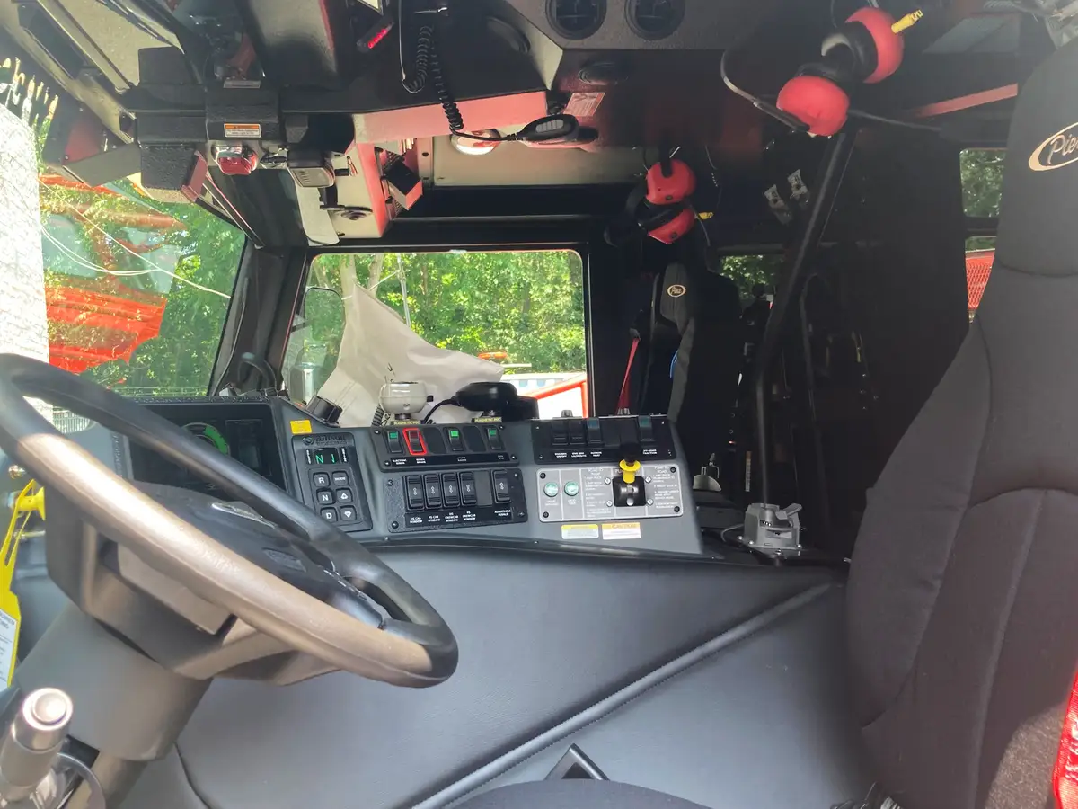 Cab control console close-up showing transmission selector, switches, and radio controls
