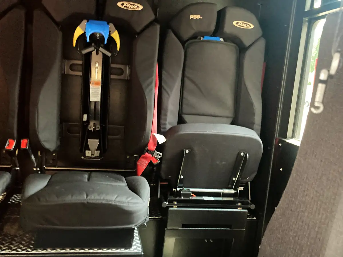Cab equipment dock close-up showing radio charging cradles on interior shelf