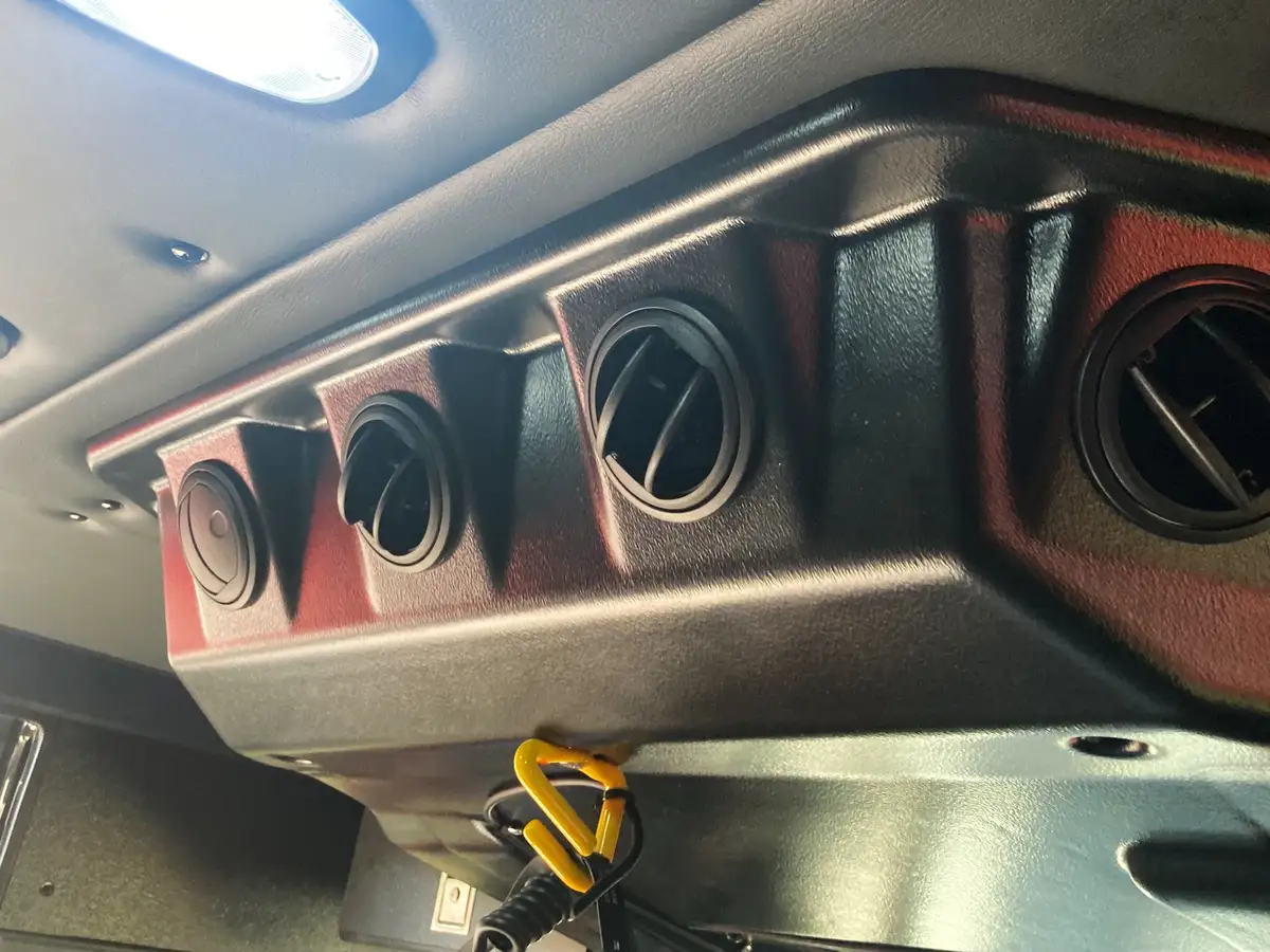 Cab interior panel close-up with rectangular latch and hardware