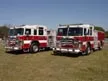 Two pumpers front-left lineup view showing cabs and front bumpers