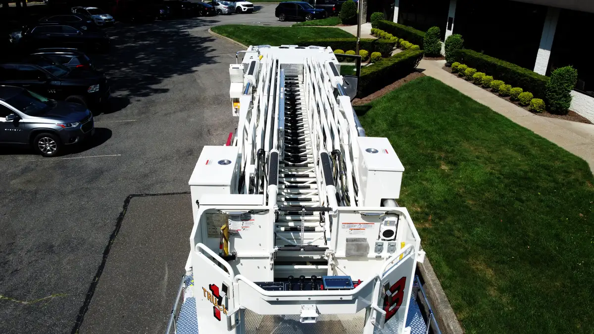 Aerial ladder bed rearward view from above showing nested ladder sections
