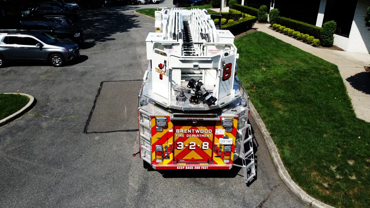 Pierce tower ladder rear view showing chevron striping and rear body layout