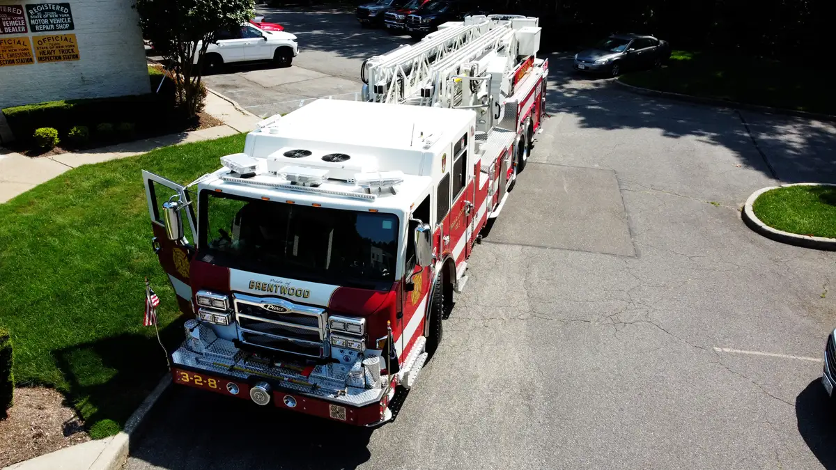Pierce tower ladder elevated front view showing cab roof and light package