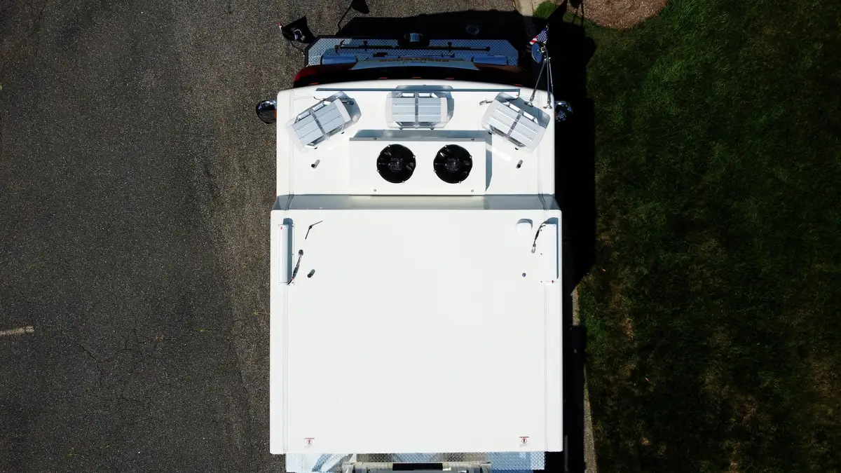 Top-down view showing cab roof, turntable area, and ladder base