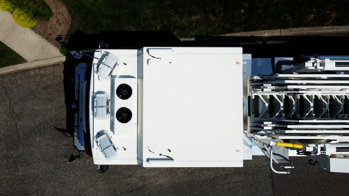 Open side compartment with pull-out tray showing rescue tools and equipment storage