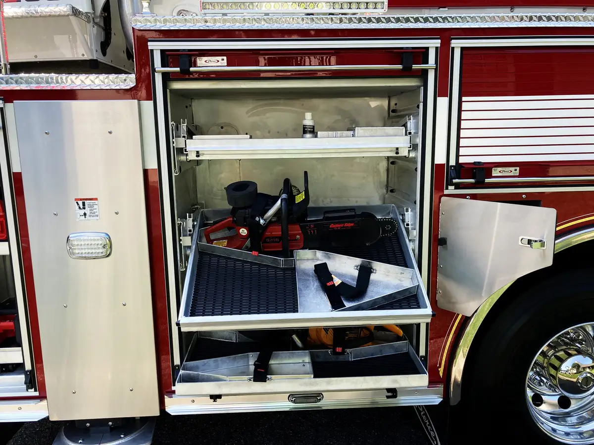 Small wheel-arch compartment close-up with mounted hand lights and tools