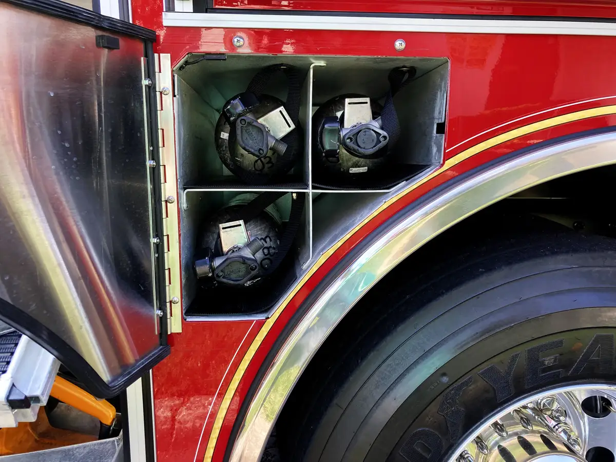 Wheel-well compartment close-up showing mounted couplings and utility fittings