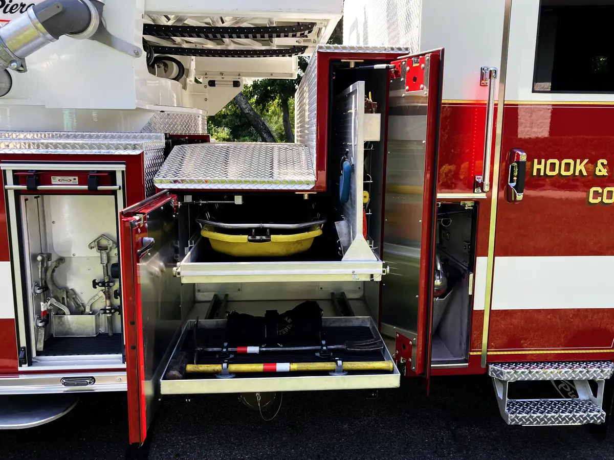 Open rescue body compartments from alternate angle showing trays and equipment bays