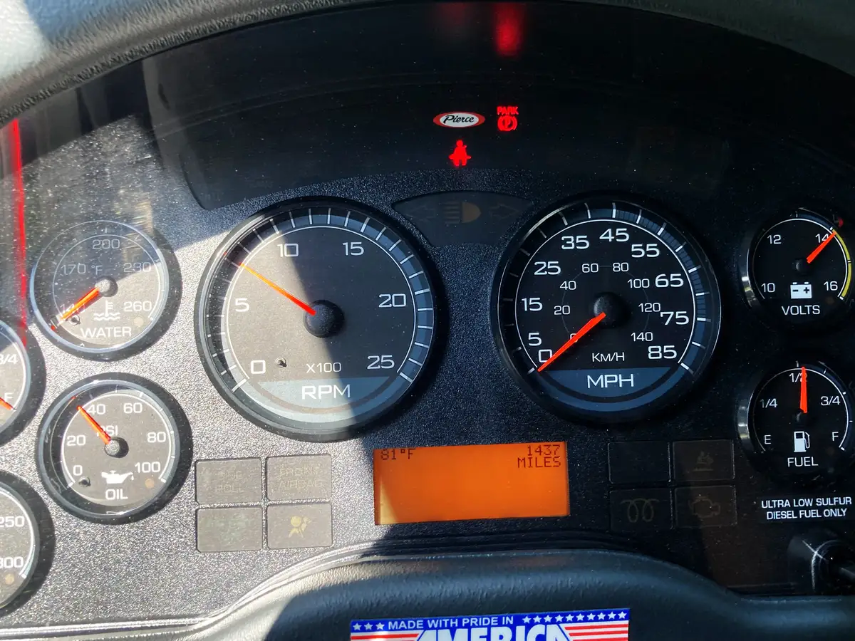 Cab center console view showing radio controls, switches, and cup holders