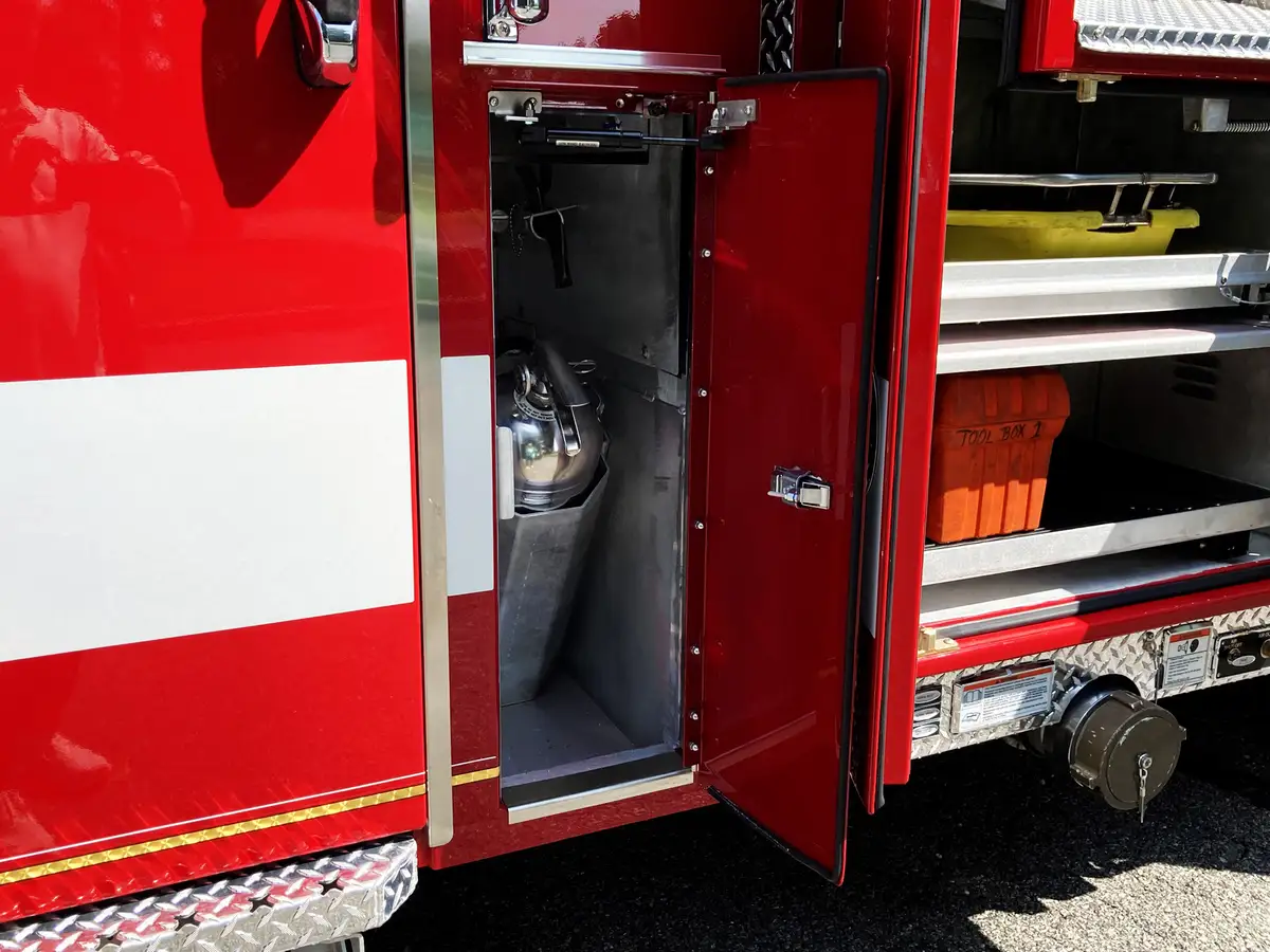 Open side compartment with mounted rescue tools on fold-down toolboard