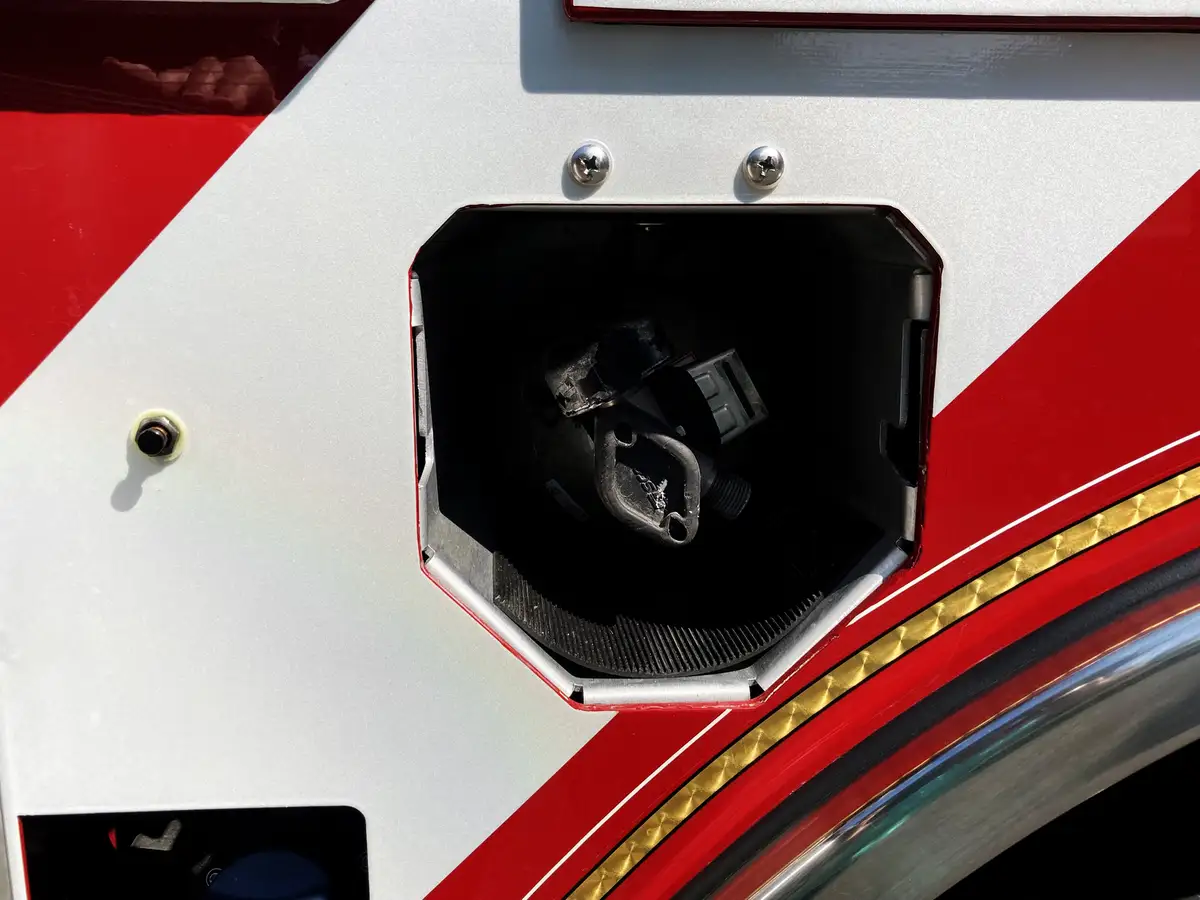 Wheel-well compartment close-up with mounted tools and fittings