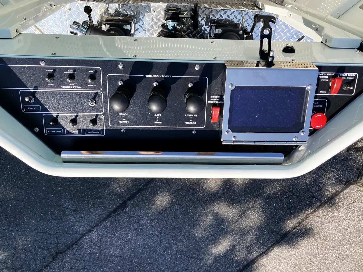 Aerial bucket control panel close-up with joystick controls and instrument labels