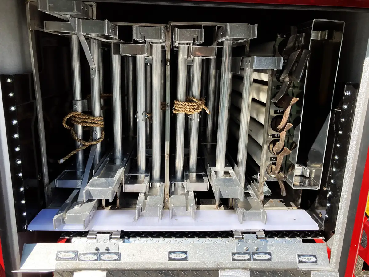 Open compartment showing battery rescue tools including cutter and spreader units