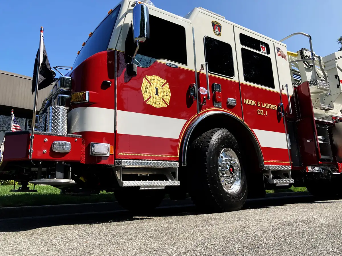Pierce tower ladder rear view with chevron striping and open stabilizer rack