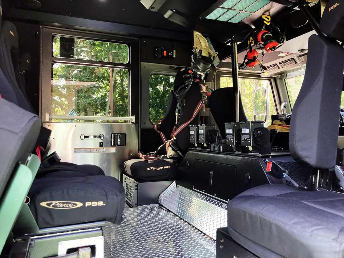 Cab ceiling close-up showing dome lights and circular air vents