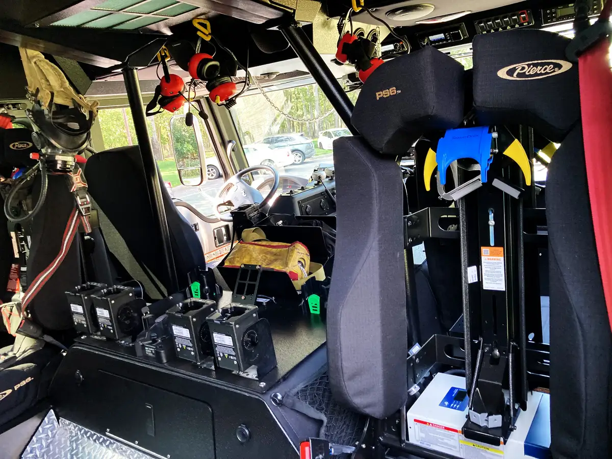 Cab interior rearward view showing charger bank and front windshield