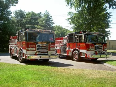 Front-left lineup view of two pumpers parked side-by-side with full front sections visible.