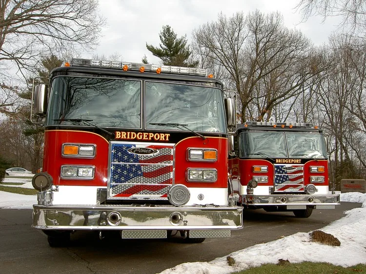 Front view of two apparatus showing grilles, bumpers, and warning lights