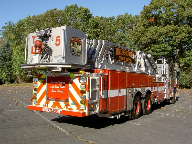 Rear-left exterior view showing bucket platform and rear chevrons