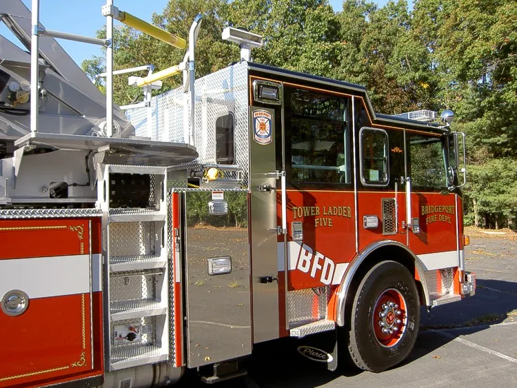 Cab-side profile close-up showing open side door and front wheel area