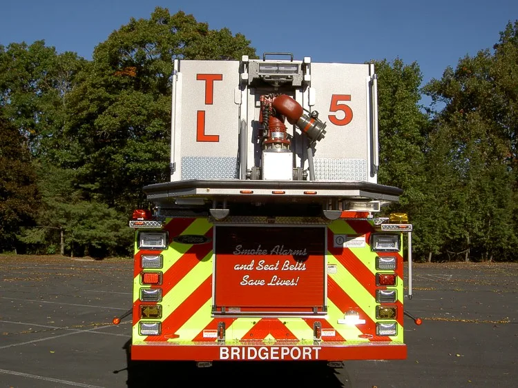 Rear view showing red-and-yellow chevrons and bucket platform at top