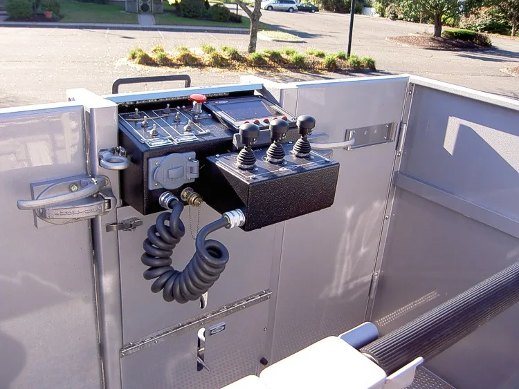 Bucket interior close-up showing control handles and communication panel
